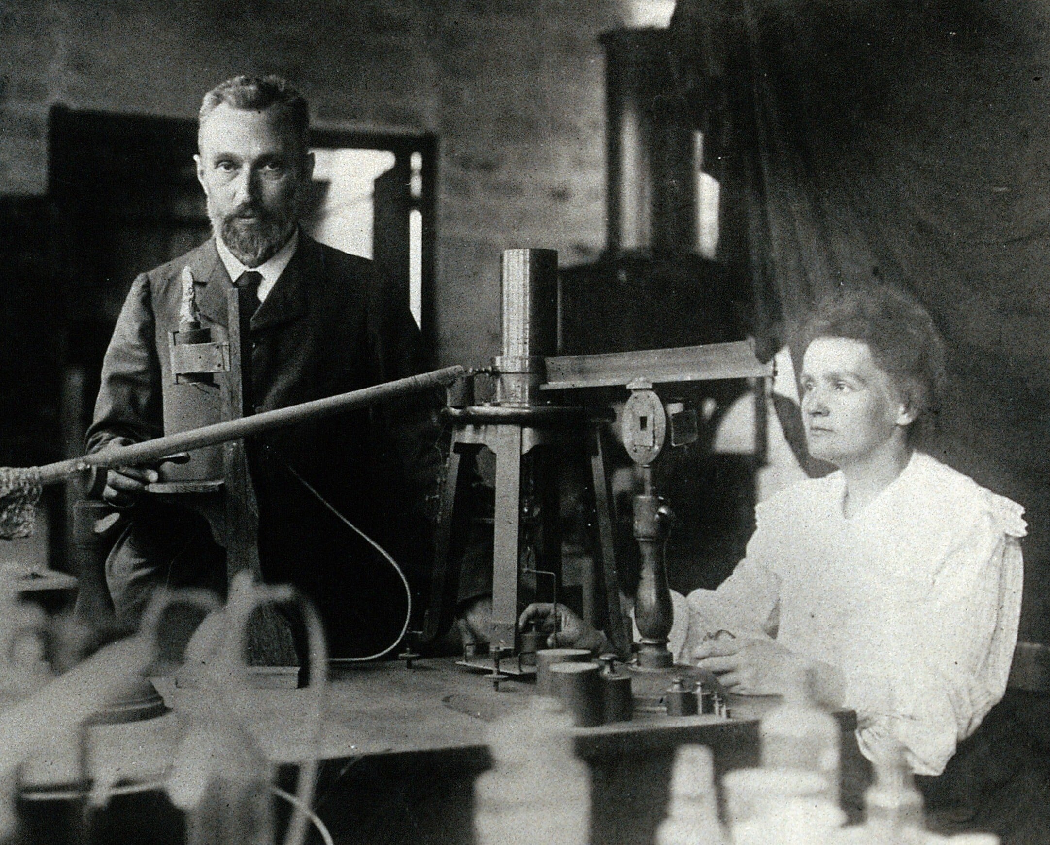 A picture of Marie and Pierrie in their laboratory - biography of Marie Curie